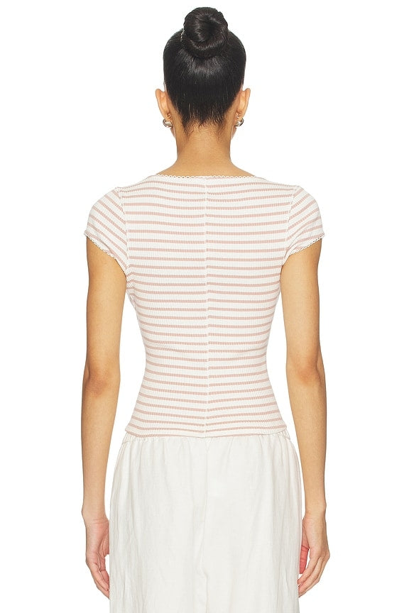 Woman wearing a striped top and white skirt from the back on a white background