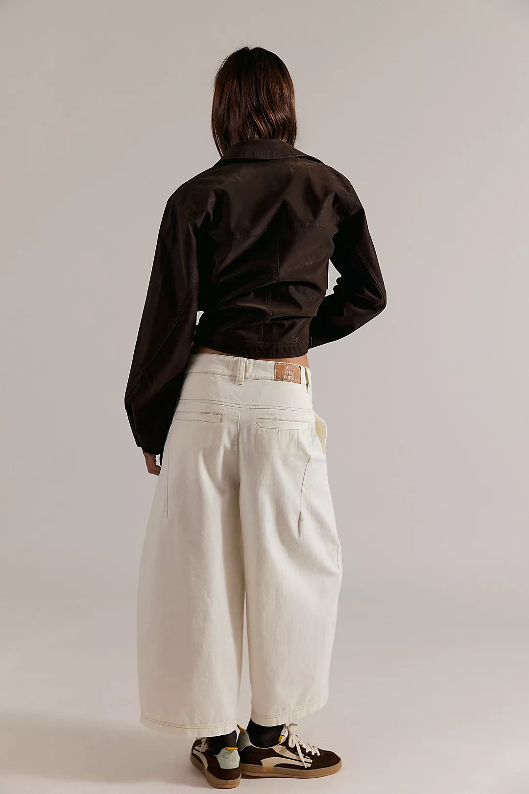 Laydown chino pants in clean ivory, back view with yoke seams and wide-leg opening
