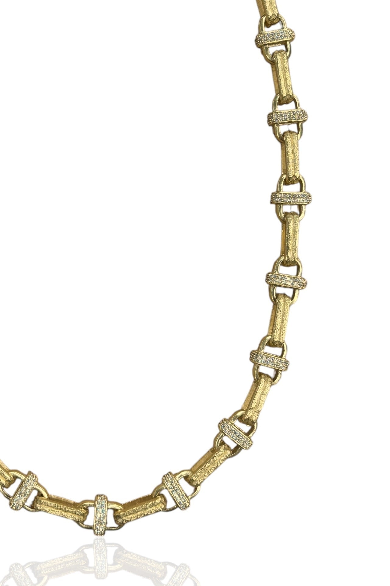 Gold-tone necklace chain with clear crystal link accents, close-up