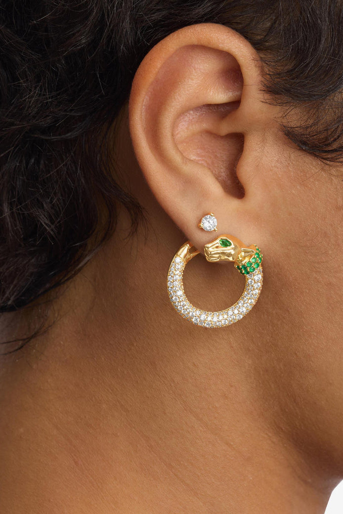 Gold-tone hoop earring with clear pavé ring and green gem and stud accents.