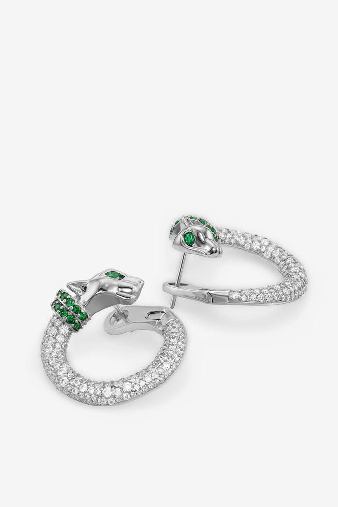 Silver-tone hoop earrings with clear pavé stones and green gem accent clusters.