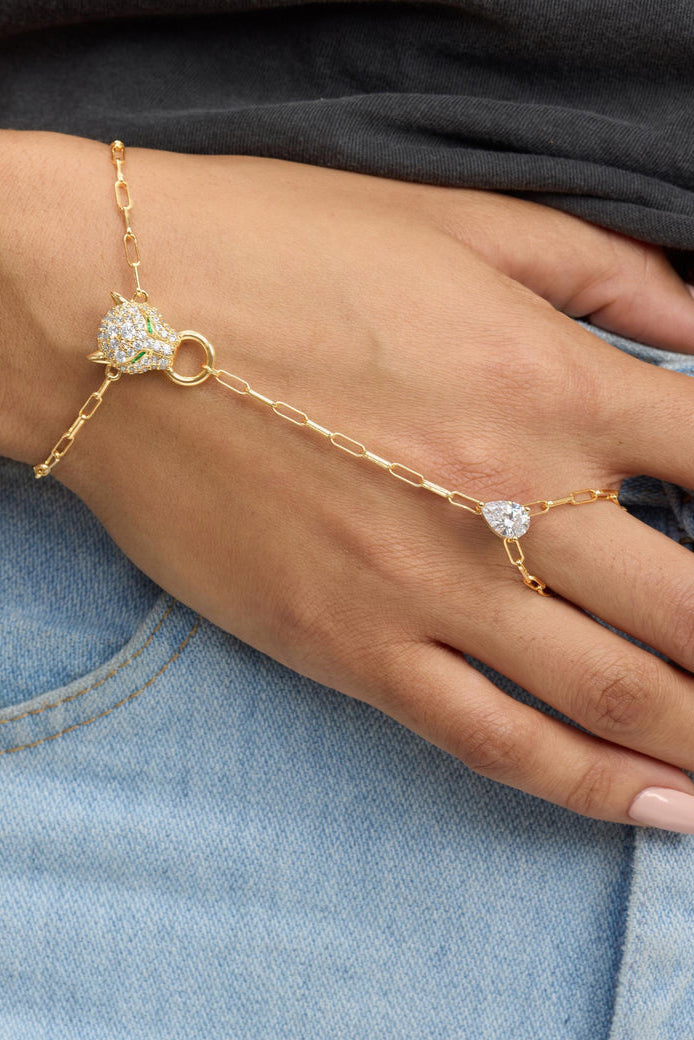 Gold-tone hand chain bracelet with pavé heart and link charms