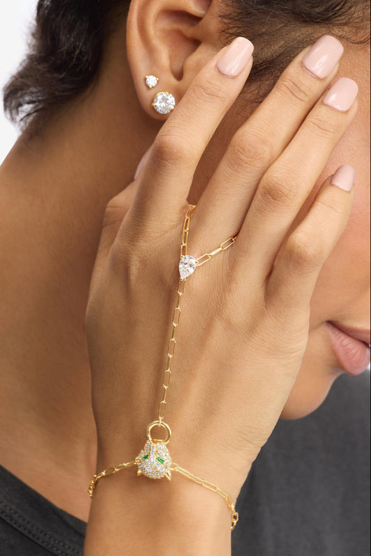 Gold-tone hand chain bracelet with pavé heart and small ring charms