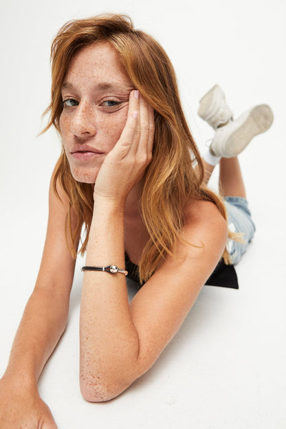 SER Intrepida bracelet with silver metal cuff and dark leather strap, round charm