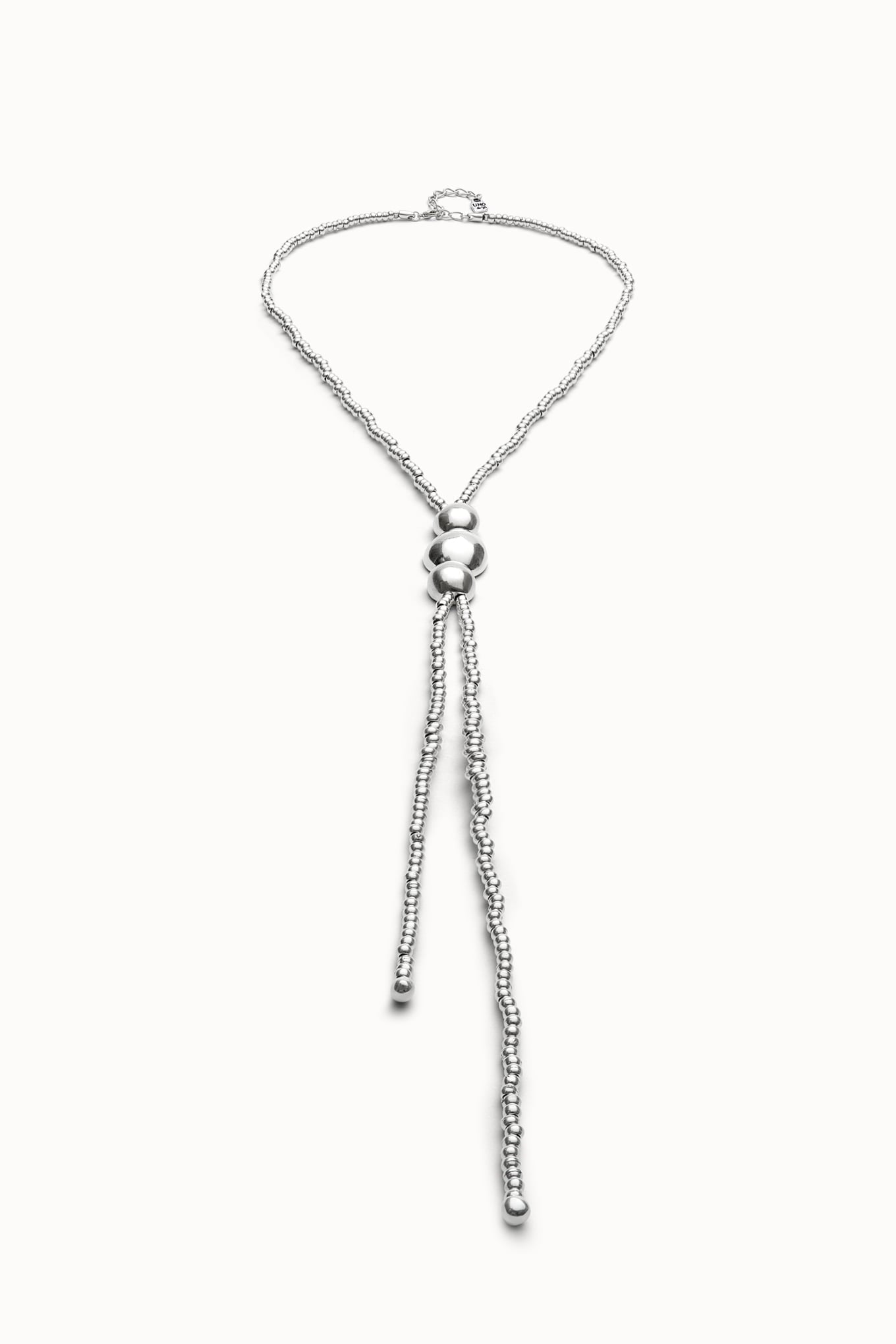 Silver heart-shaped pendant necklace with bead tassel and small clasp