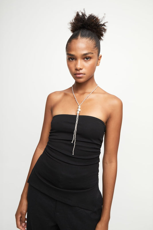 Silver pendant necklace with long tassel chain, worn on a thin chain