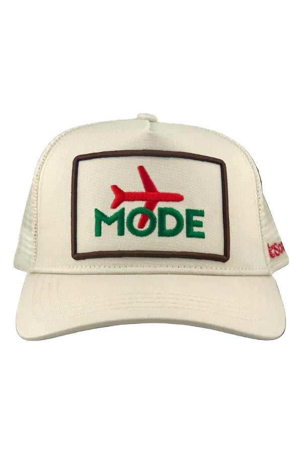 Cream trucker cap with front embroidered patch reading MODE