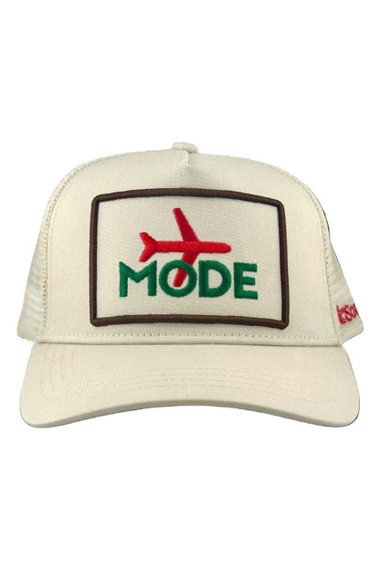 Cream trucker cap with front embroidered patch reading MODE