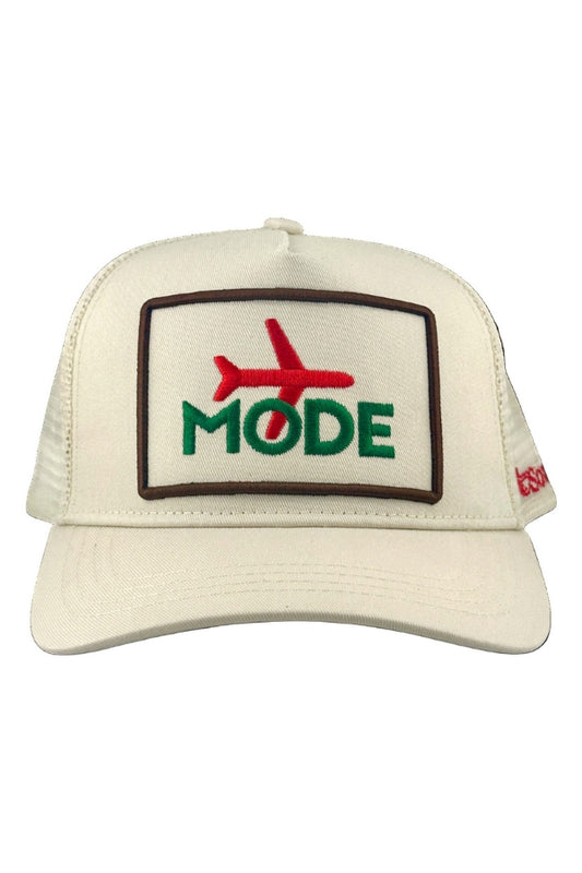 Cream trucker cap with front embroidered patch reading MODE
