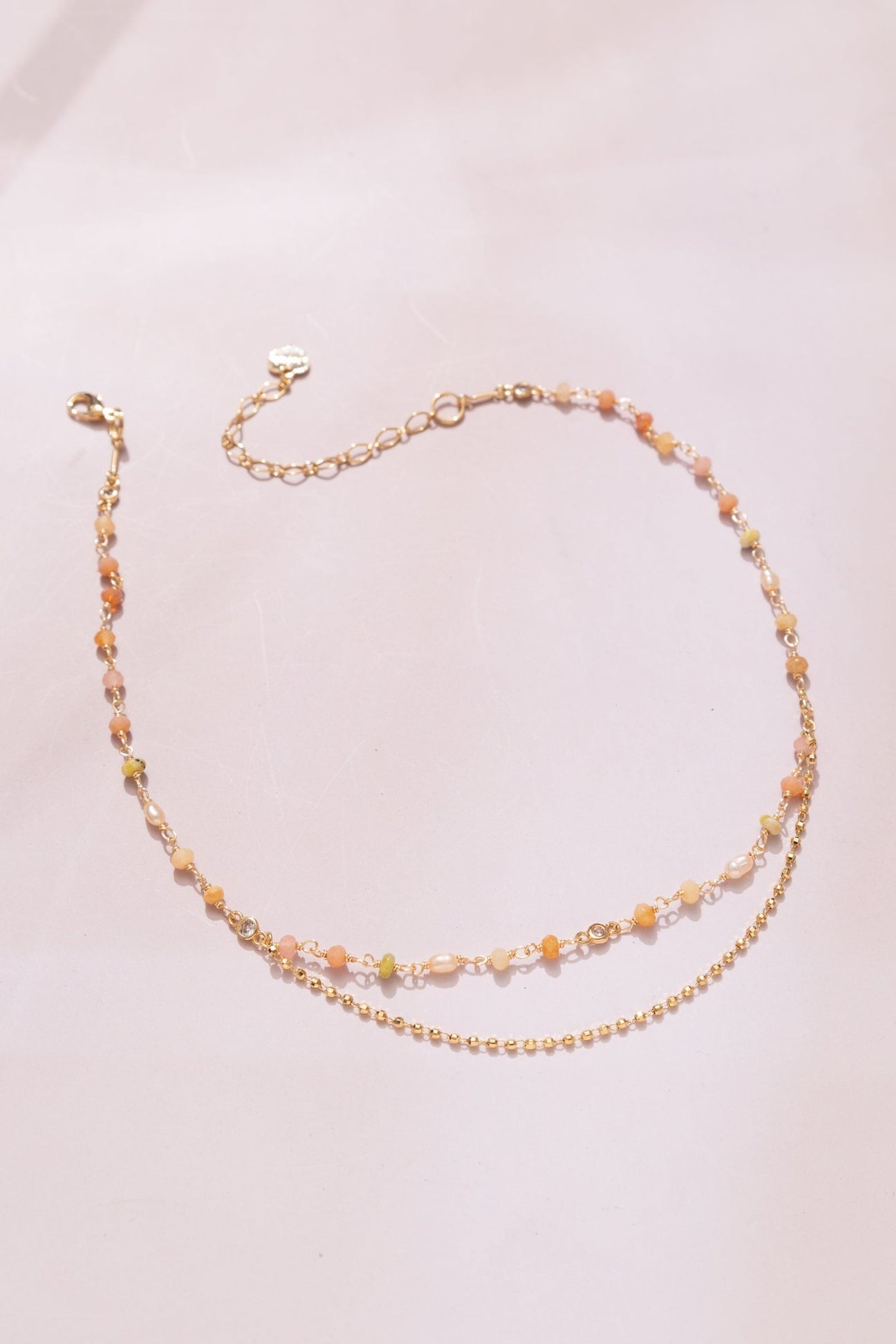 Two-layer beaded necklace with peach multi beads and gold-tone chain links