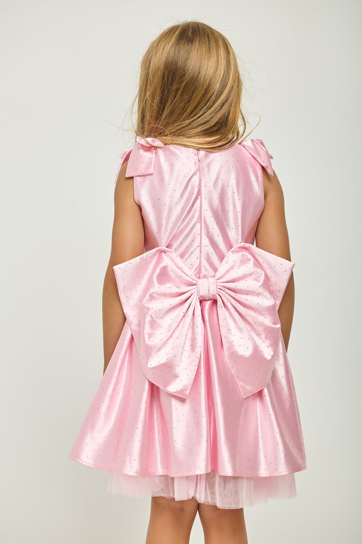 Pink sleeveless back dress with large waist bow and layered skirt hem
