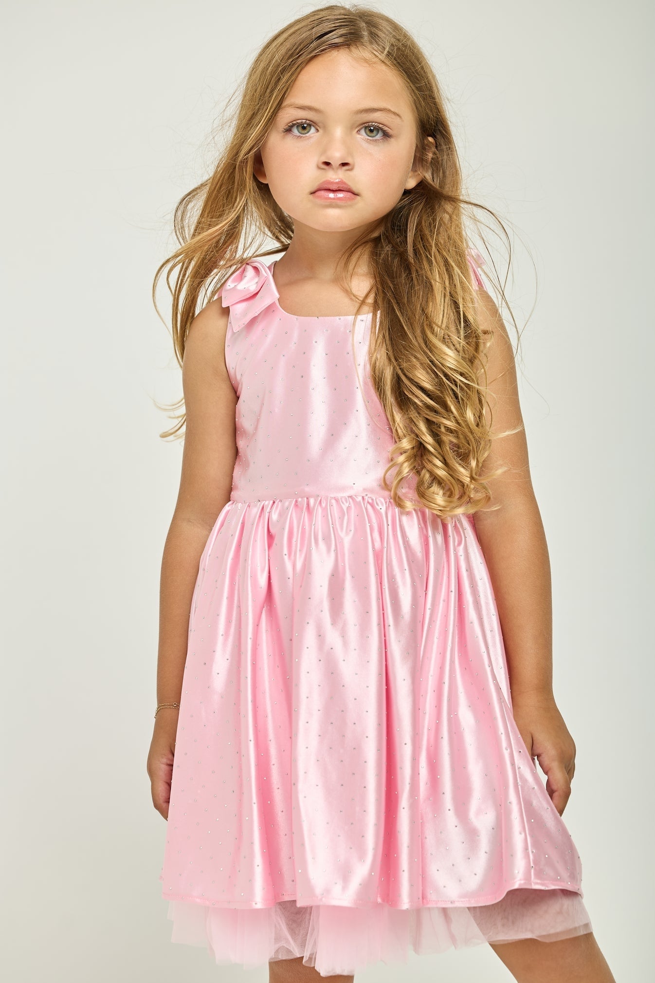 Pink sleeveless birthday dress with bow straps and gathered skirt