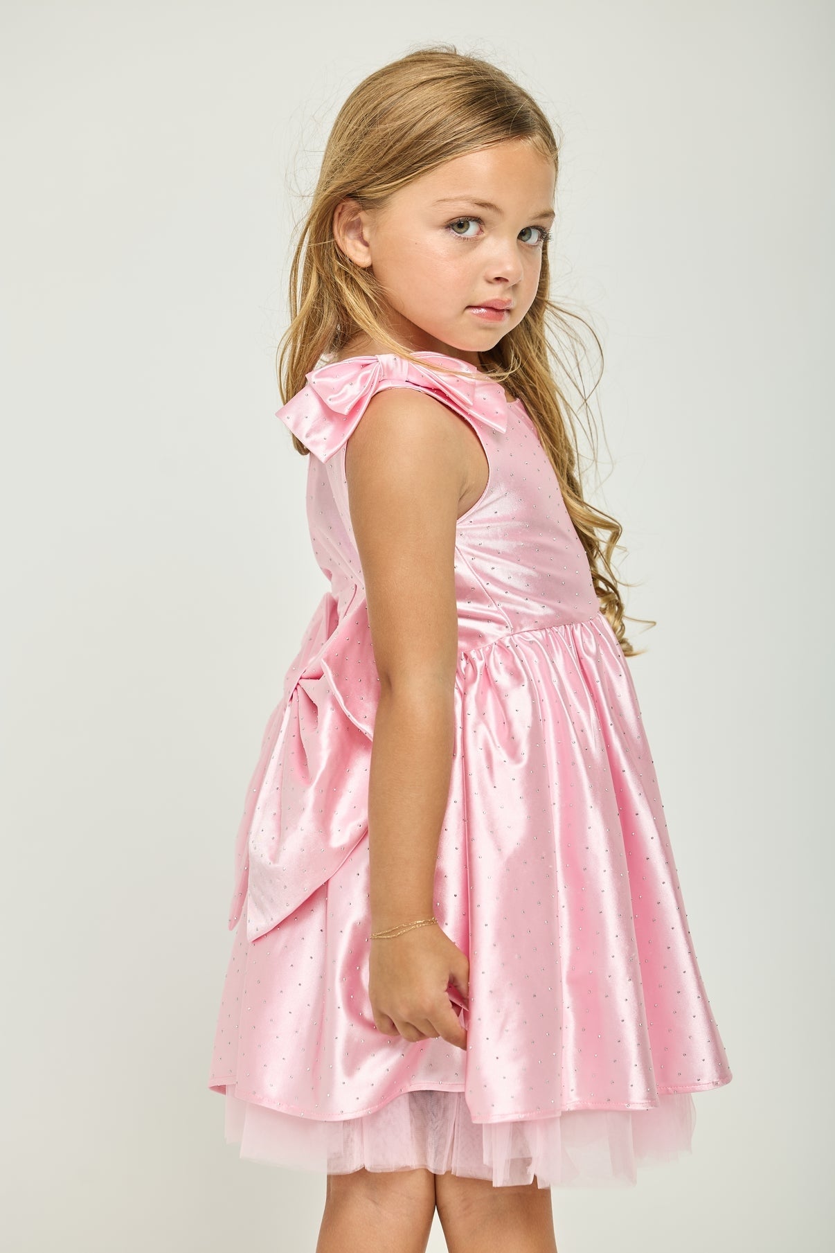 Pink sleeveless dress with bow detail and layered hem skirt