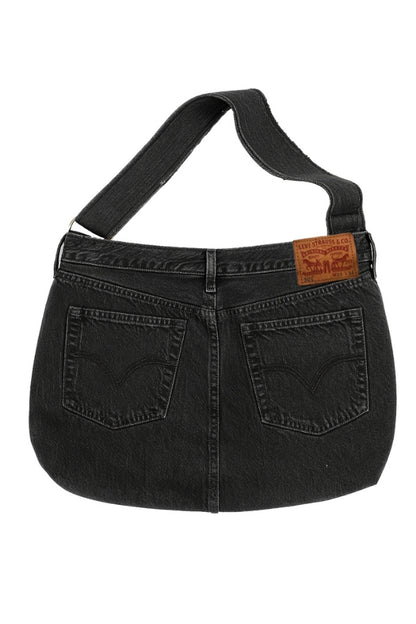 Black denim handbag with a visible brand label on a white background