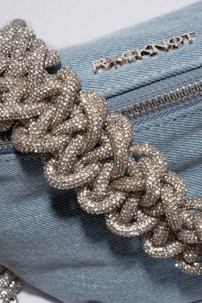 Blue denim bag with a decorative silver chain and 'Knot' branding.