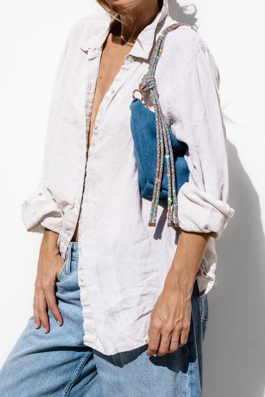 Denim blue shoulder bag with multicolor beaded strap and hanging tassels