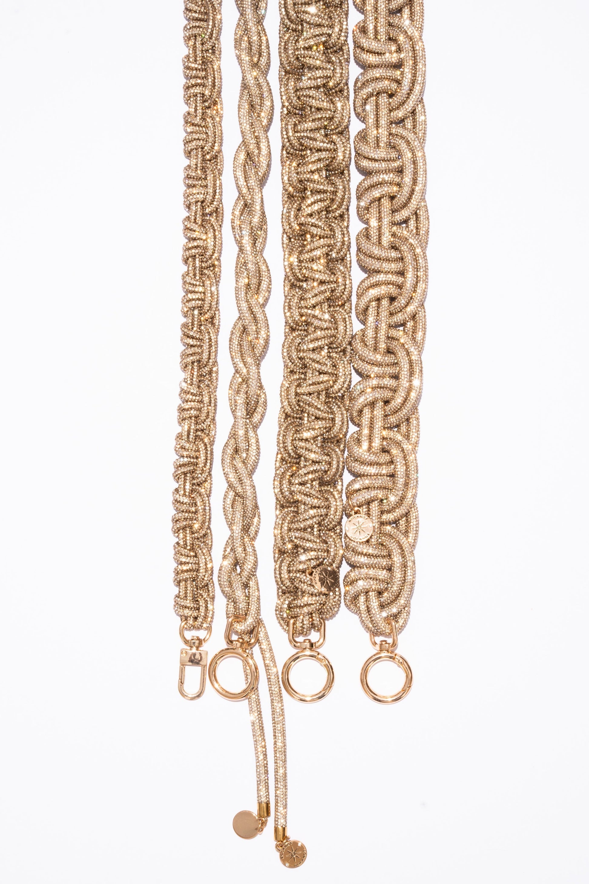 Braided champagne straps with gold hardware on a white background