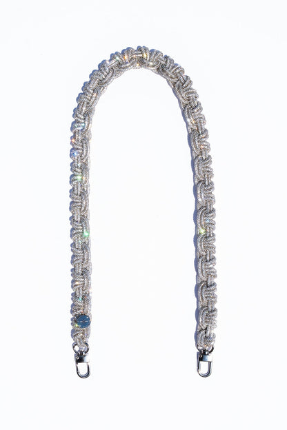 Decorative bag strap with crystals on a white background