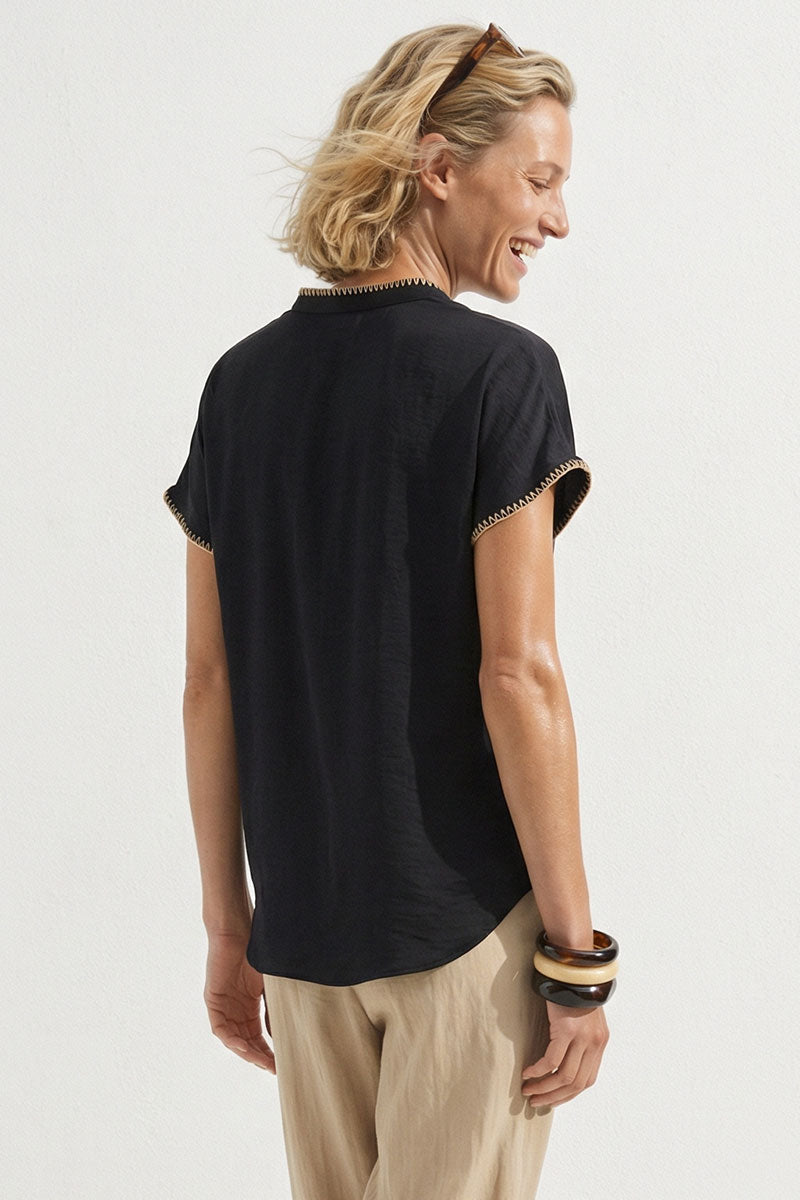 Black drop-shoulder blouse back view with short sleeves and whipstitch edging