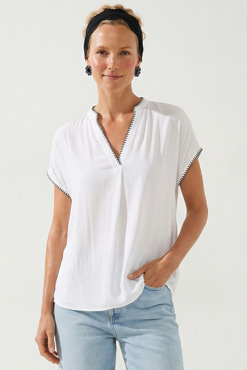 Off-white V-neck drop-shoulder blouse with whipstitch edging and short sleeves