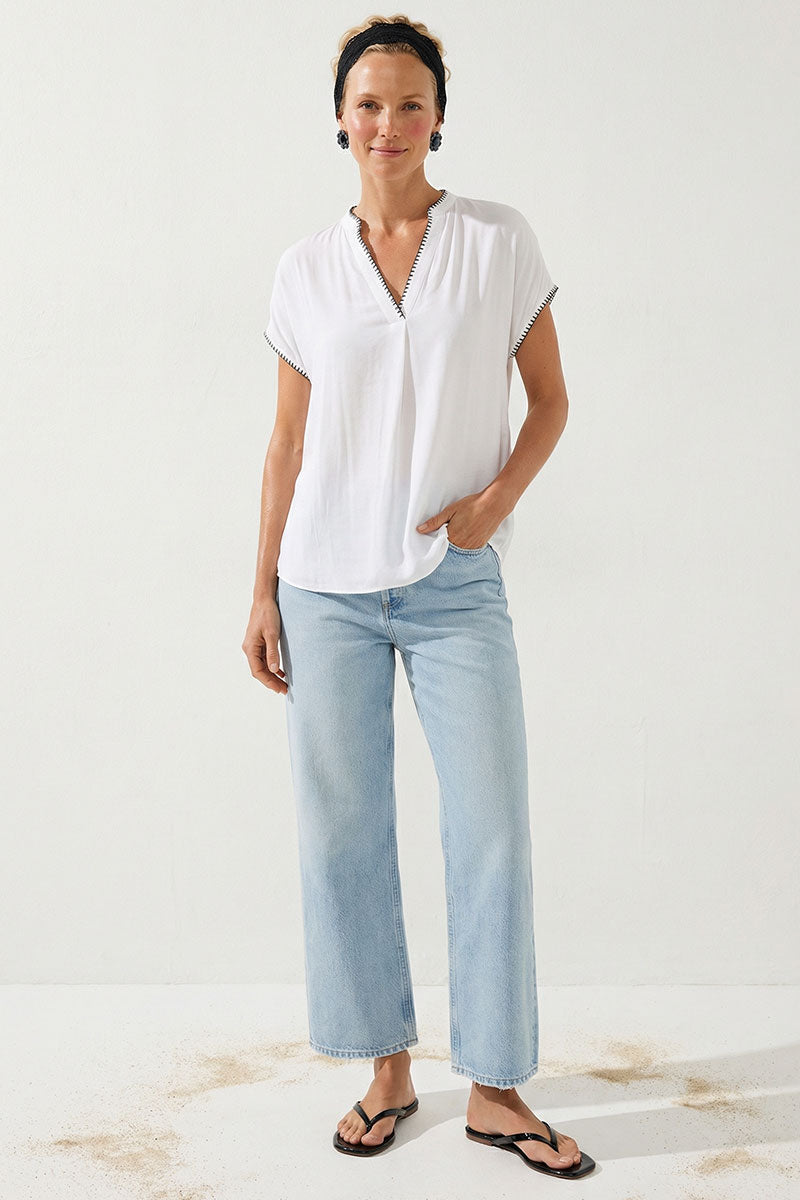 Off-white drop-shoulder blouse with V-neck and whipstitch trim, short sleeves