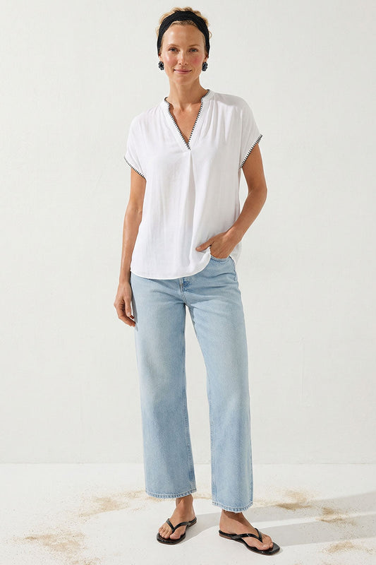 Off-white drop-shoulder blouse with V-neck and whipstitch trim, short sleeves