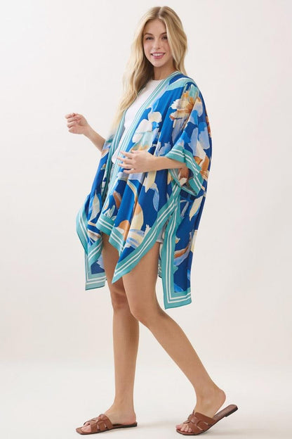 Blue floral print kimono with wide sleeves and teal striped trim