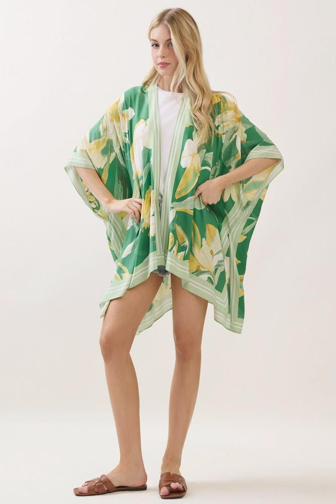 Green floral print kimono with cape-like sleeves and yellow leaf pattern