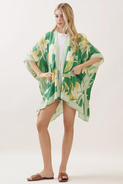 Green floral print kimono with cape-like sleeves and yellow leaf pattern