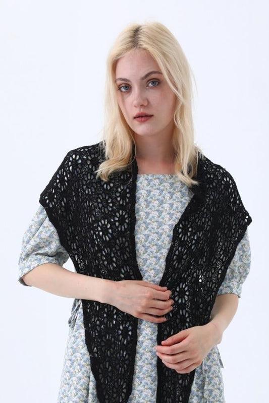 Black boho crochet lace shawl, openwork pattern draped over shoulders