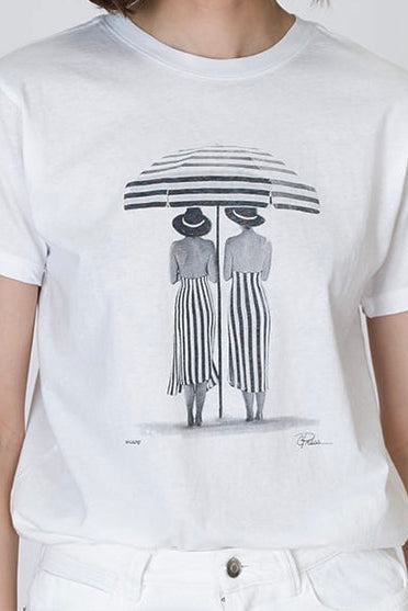 Shade Mushie tee worn white, close view of two figures under striped arch print