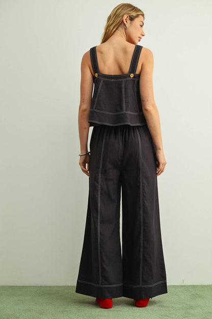 Back view of woman wearing navy wide leg linen pants with a matching navy linen sleeveless top