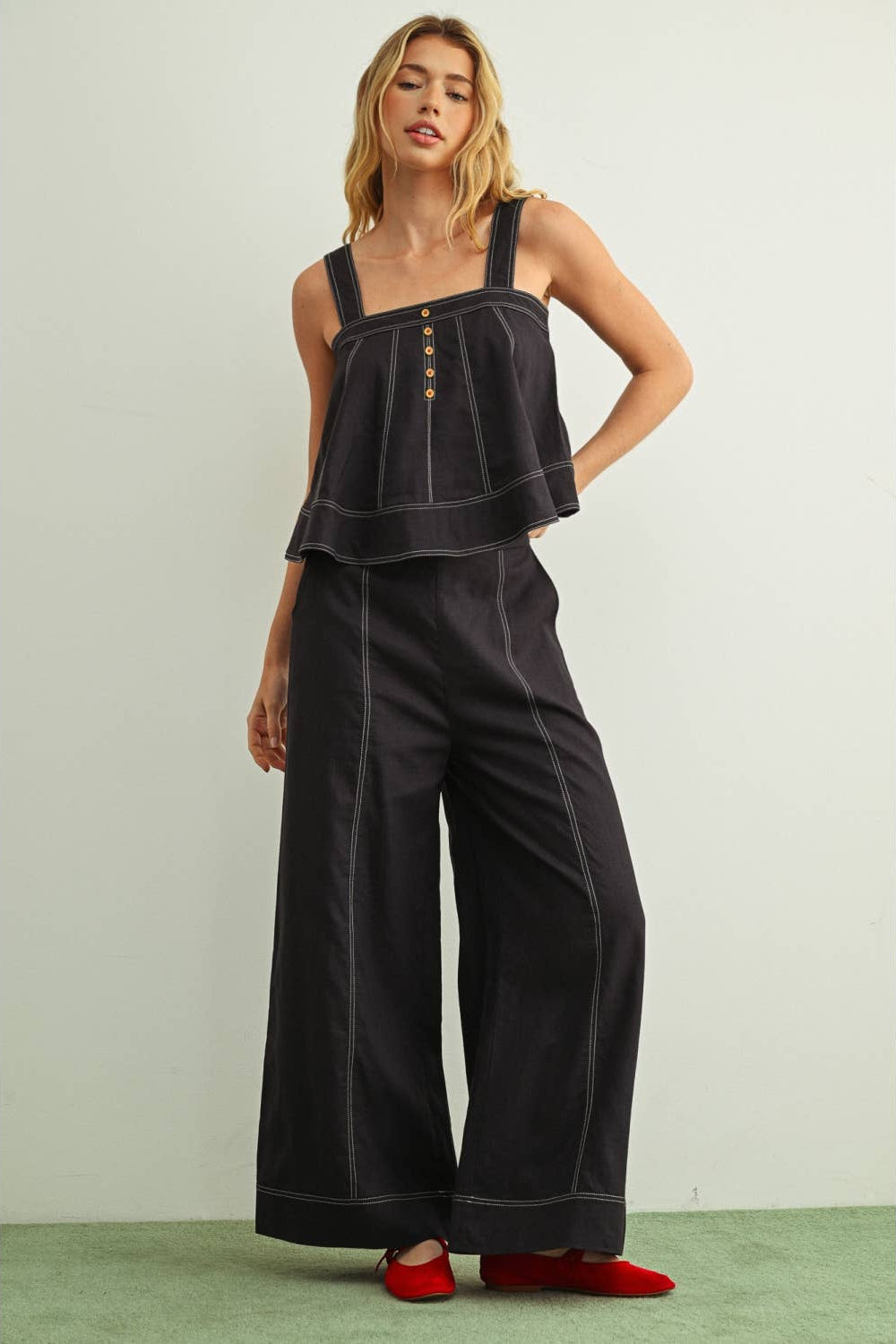 Front view of woman wearing navy wide leg linen pants with a matching navy linen sleeveless top