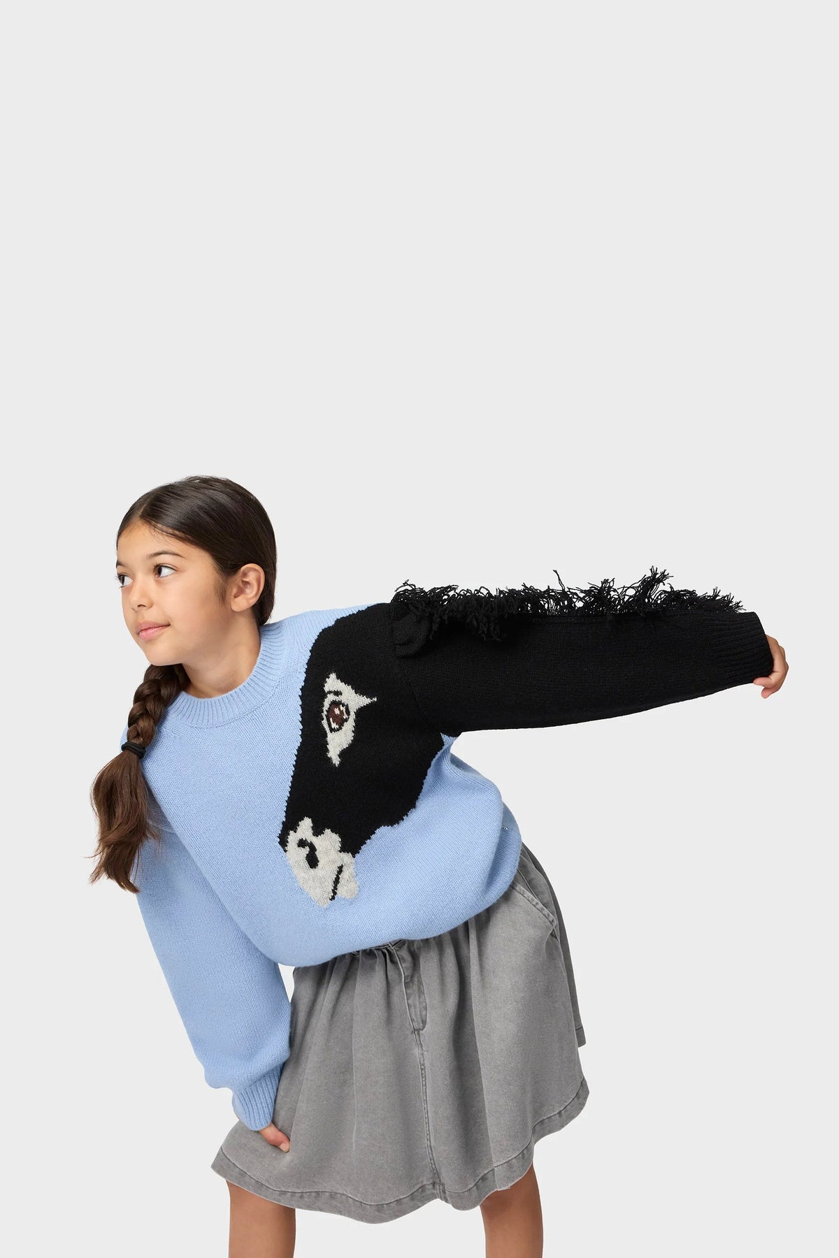 Light blue crewneck sweatshirt with penguin graphic and black fuzzy sleeve accent