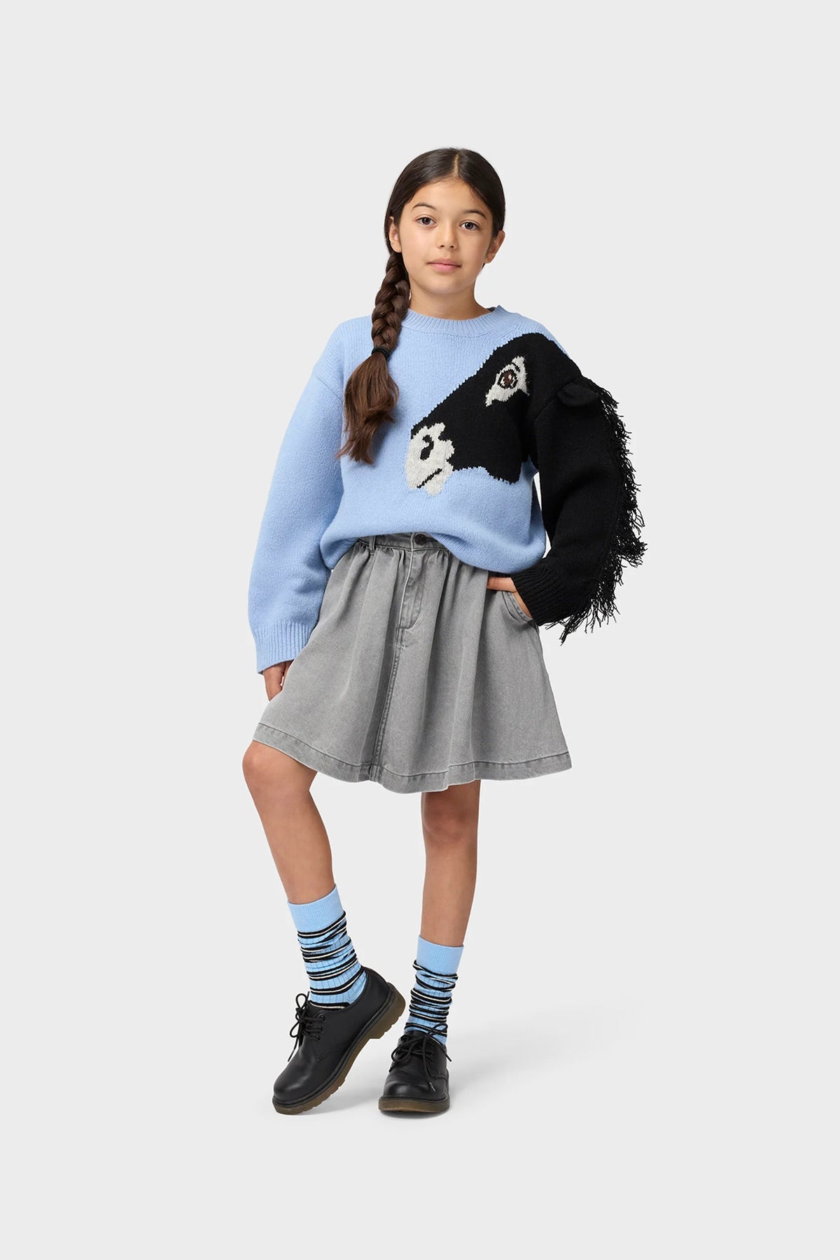 Light blue crewneck sweatshirt with black fuzzy sleeve and penguin graphic, worn by child