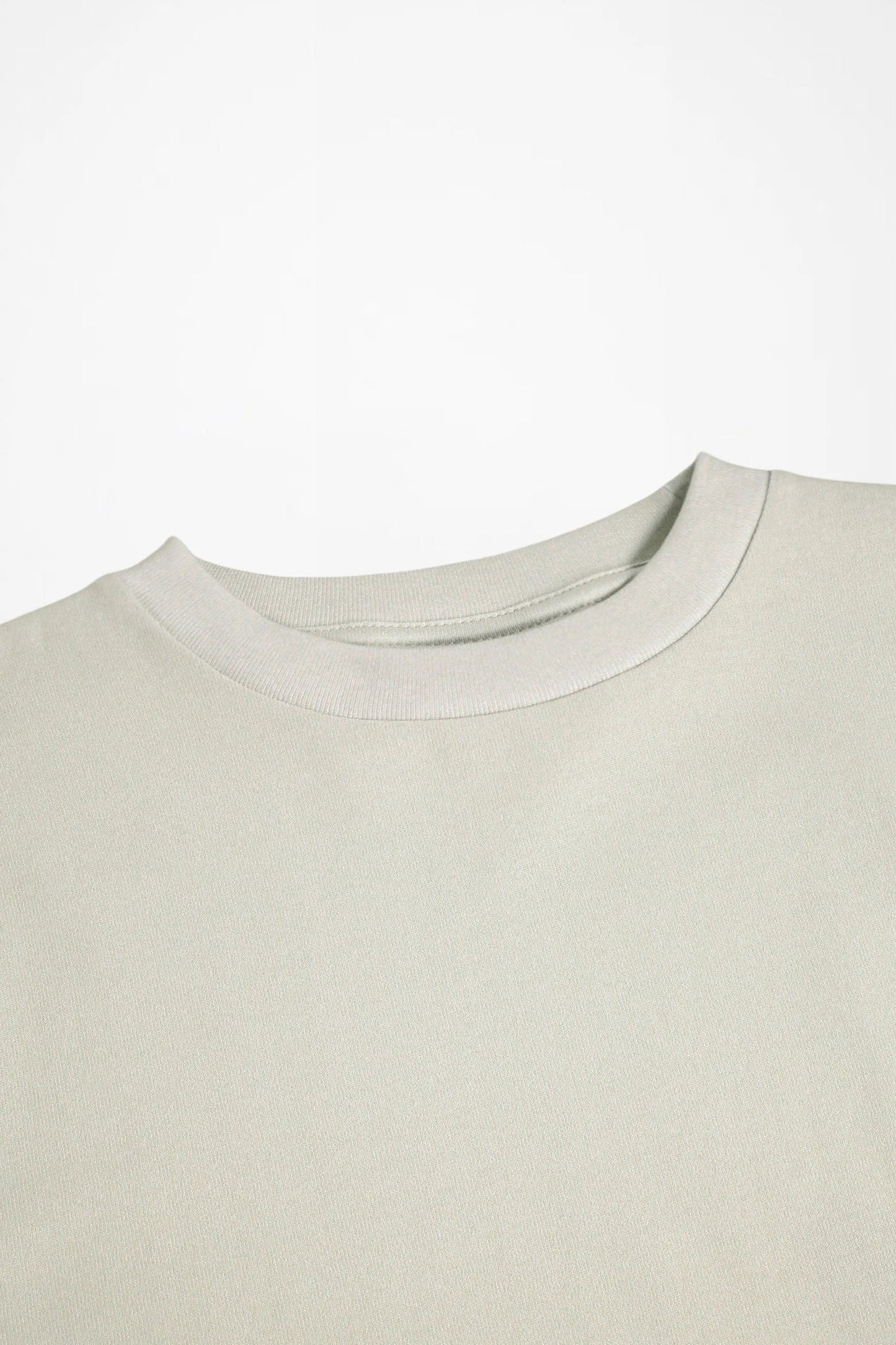 Light cream crewneck long-sleeve shirt, close-up of neckline and stitching