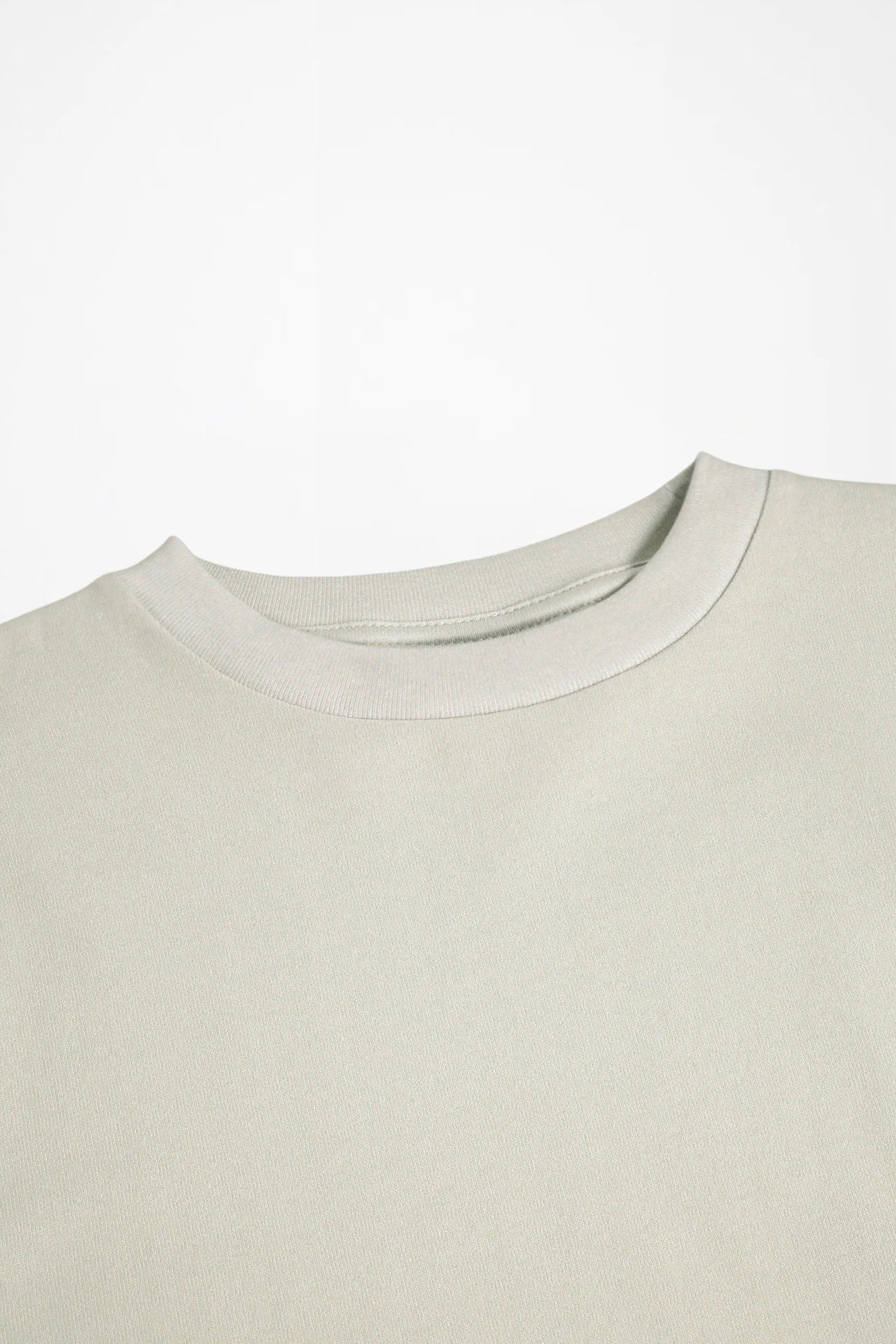 Light cream crewneck long-sleeve shirt, close-up of neckline and stitching