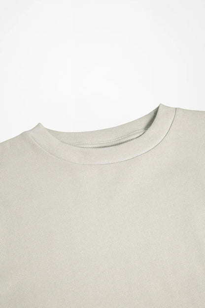 Light cream crewneck long-sleeve shirt, close-up of neckline and stitching
