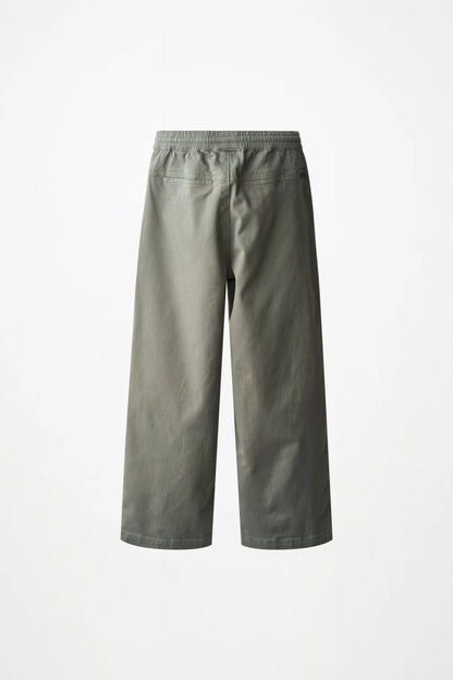 A pair of wide-leg cropped pants in a muted sage green color, shown from the back against a plain white background.