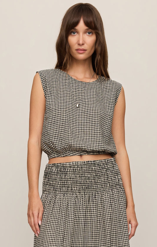 Front view of woman wearing Merit Gingham top in black & white with matching skirt 