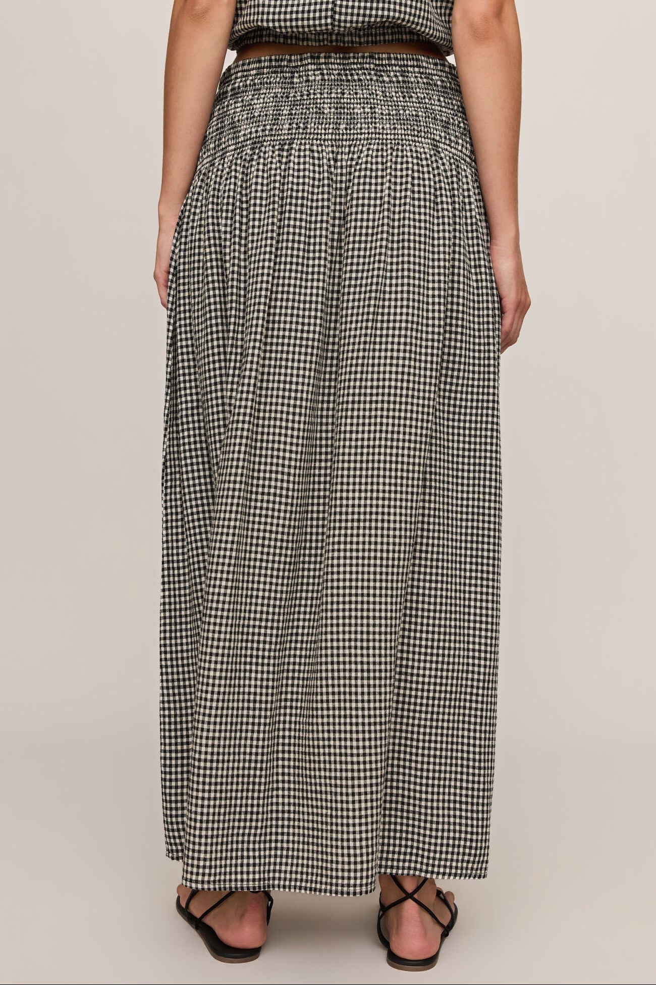 Back view of woman wearing brooke gingham skirt in black & white 