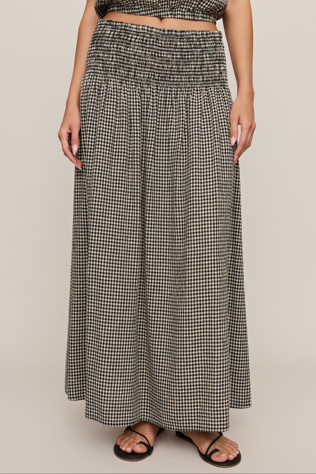 Front view of woman wearing brooke gingham skirt in black & white 