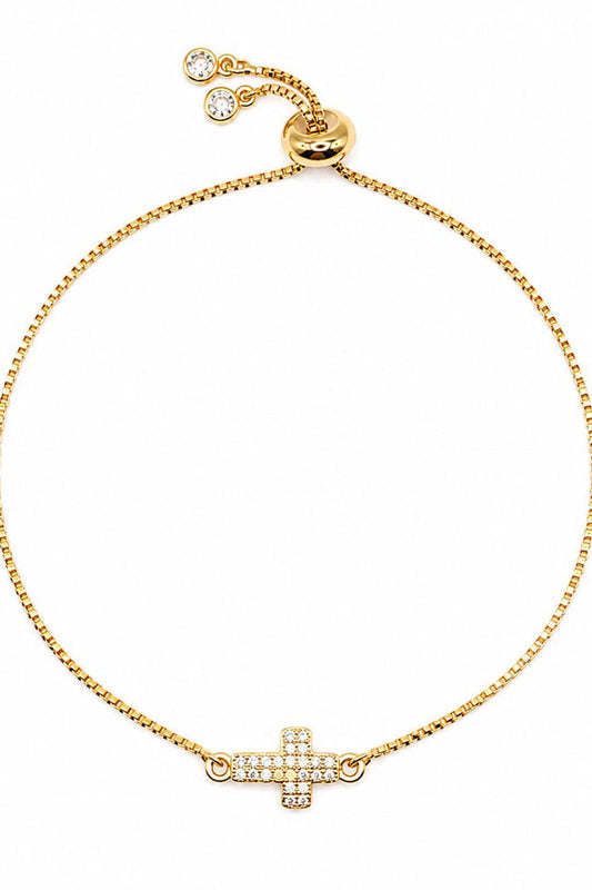 Gold pull chain bracelet with CZ cross charm and small round details
