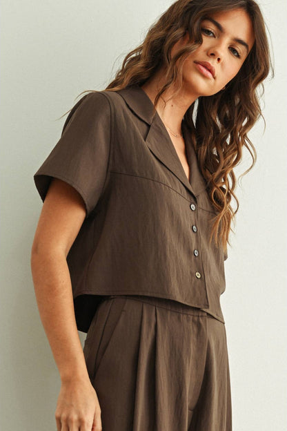 Woman wearing a brown rayon outfit against a light background
