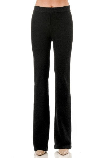 Black flared knit pants shown on a model from the waist down against a plain white background.