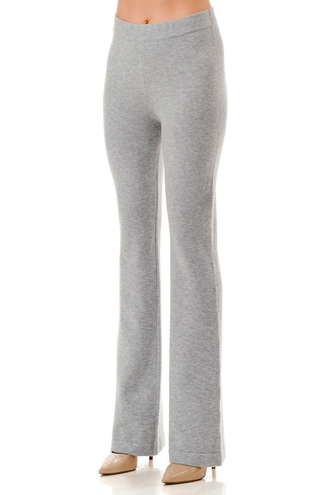 A model from the waist down wearing light grey heathered flare pants and beige pointed-toe heels, shown against a plain white studio background.