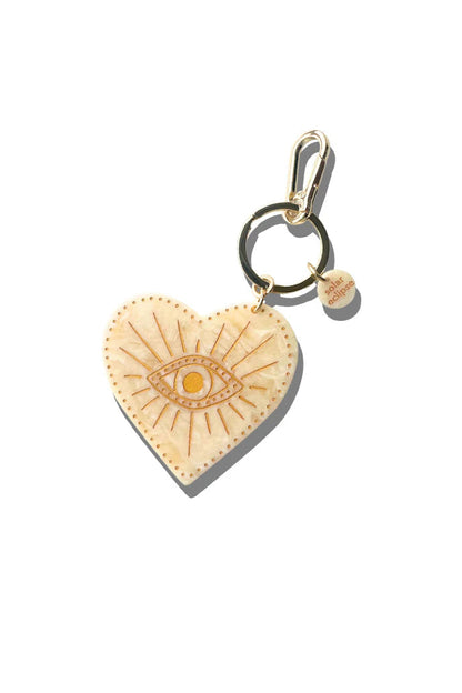 Celestial Heart-shaped charm with eye design on a white background