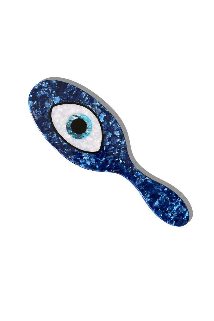Blue hairbrush with evil eye design on a white background