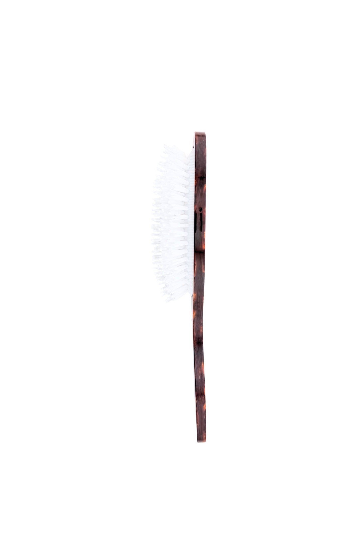 Hairbrush with a tortoiseshell patterned brown handle and white bristles, shown vertically against a plain white background.