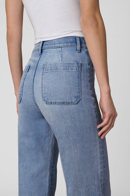 Close up back pocket view of a Woman wearing a white t-shirt and Joe's Mia Patch Pocket blue jeans in Amiable color on a white background